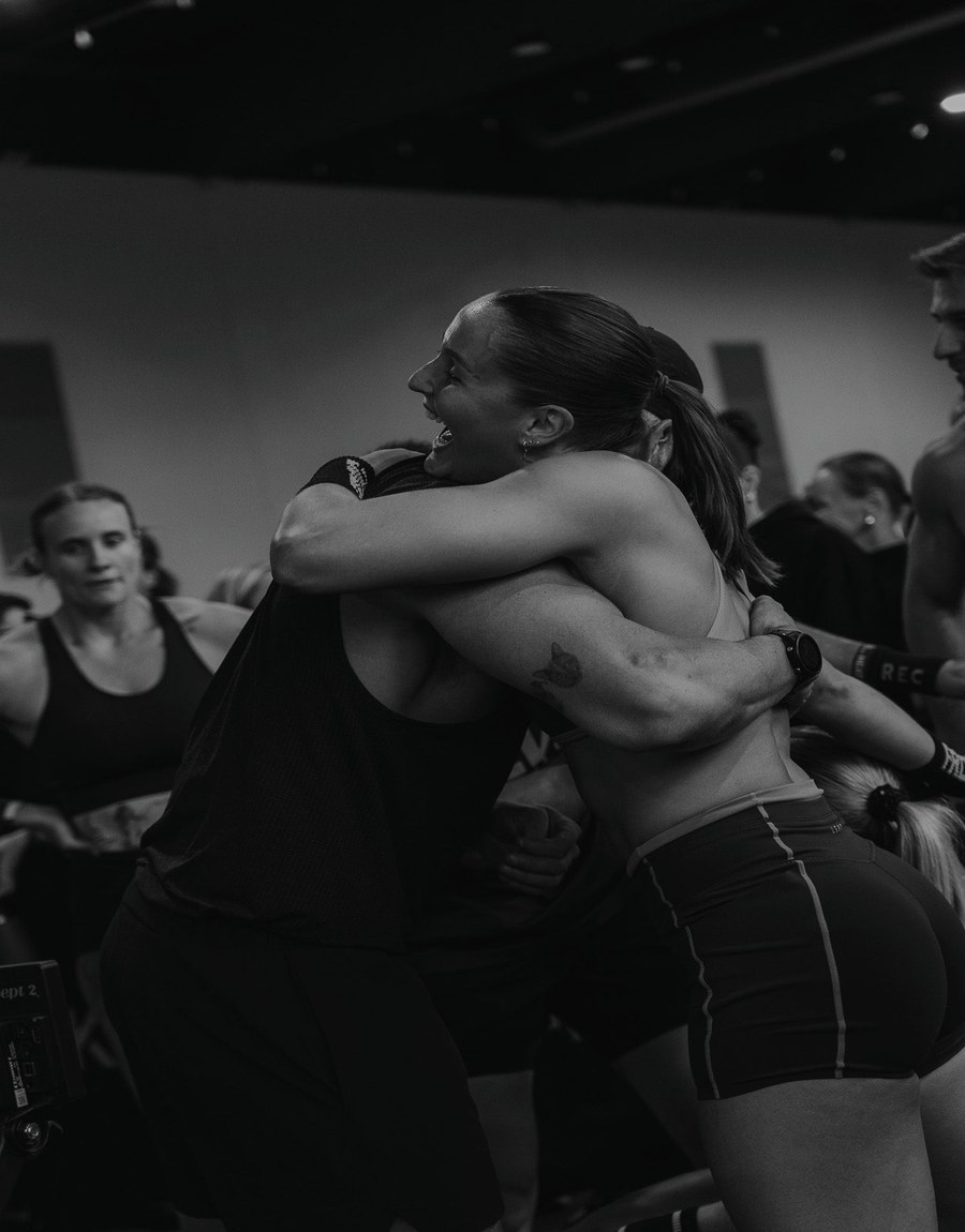 Two REVL athletes arm in arm after a session